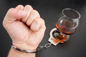 A Hand Locked To Glass Of Alcohol A-Hand-Locked-To-Glass-Of-Alco-13387568