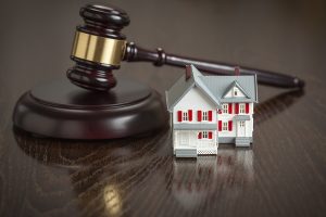 Gavel and Small Model House on Wooden Table. bankruptcy4